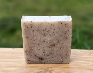 handmade shea butter soap with coffee granules and clove essential oil